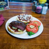 Pitmasters Mac Rib Sandwich · 100% boneless st. Louis ribs, pickles, onions, BBQ sauce on a kaiser roll.