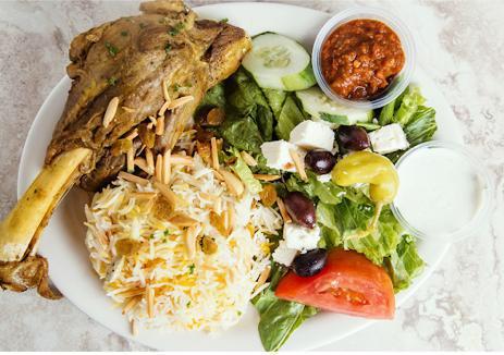Lamb Shank Platter · Slowly cooked lamb shank seasoned with chef’s special spices and served with seasoned basmati rice. Served with basmati rice, Greek salad, warm pita, and choice of sauce.