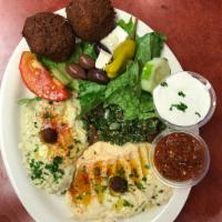 Vegetarian Platter · Combination of hummus, baba ganouj, tabouleh, and Greek salad with two falafel patties. Serv...