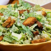 Caesar Salad · Hearts of romaine tossed in Caesar dressing and topped with Parmesan cheese, and croutons. E...