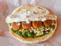 Falafel Pita · Falafel with Spinach, Onions, Tomatoes, Cucumbers, Olives, Feta and Tzatziki.