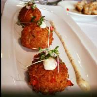 Goat Cheese Croquettes · Goat cheese croquettes drizzled with guava sauce