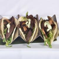 3 Piece Steak Tacos · Hanger steak, grilled peppers, onions, queso fresco and tomatillo sauce. Served in corn tort...