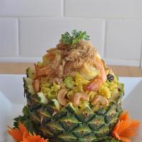Pineapple Fried Rice · Fried rice with chicken, shrimp, egg, pineapple chunk, onions, pea, carrot, raisin in a touc...
