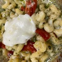 Pesto Cavatappi · Cavatappi noodles smoothed in a fresh alfredo and pesto sauce topped with fresh mozzarella a...