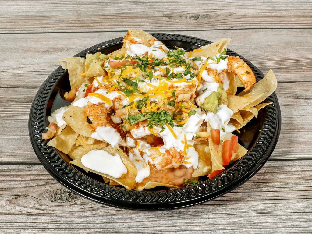 Shrimp Nachos  · Jumbo shrimp grilled loaded with beans and guacamole sour cream and pico de Gallo melted cheese 