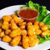 Cheese Curds · Aged Wisconsin white Cheddar cheese, breaded and fried to perfection, served with marinara s...