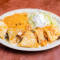 Chicken and Mushroom Quesadilla · A giant tortilla filled with chicken, mushrooms and cheese. Served with rice, lettuce and so...