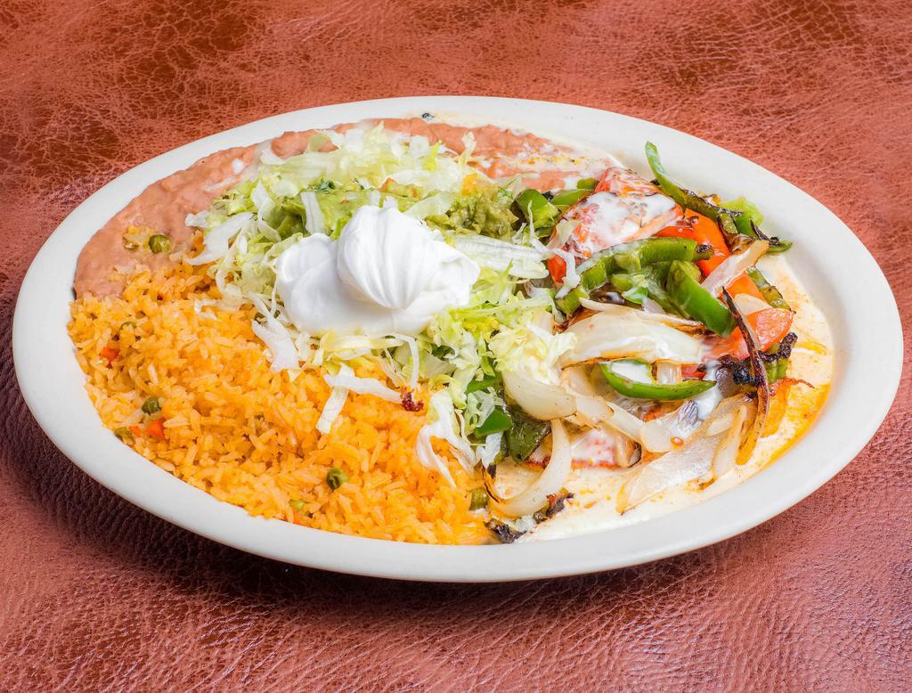 Pollo Sabroso · Grilled marinated chicken breast layered with fresh sauteed vegetables and smothered with cheese. Served with Mexican rice, lettuce, guacamole, sour cream, refried beans and tortillas.
