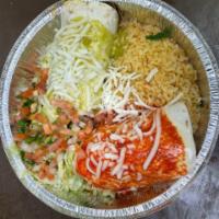 Macho Burrito · A delicious burrito filled with carnitas, shrimp, chicken and steak. Finished with queso, to...