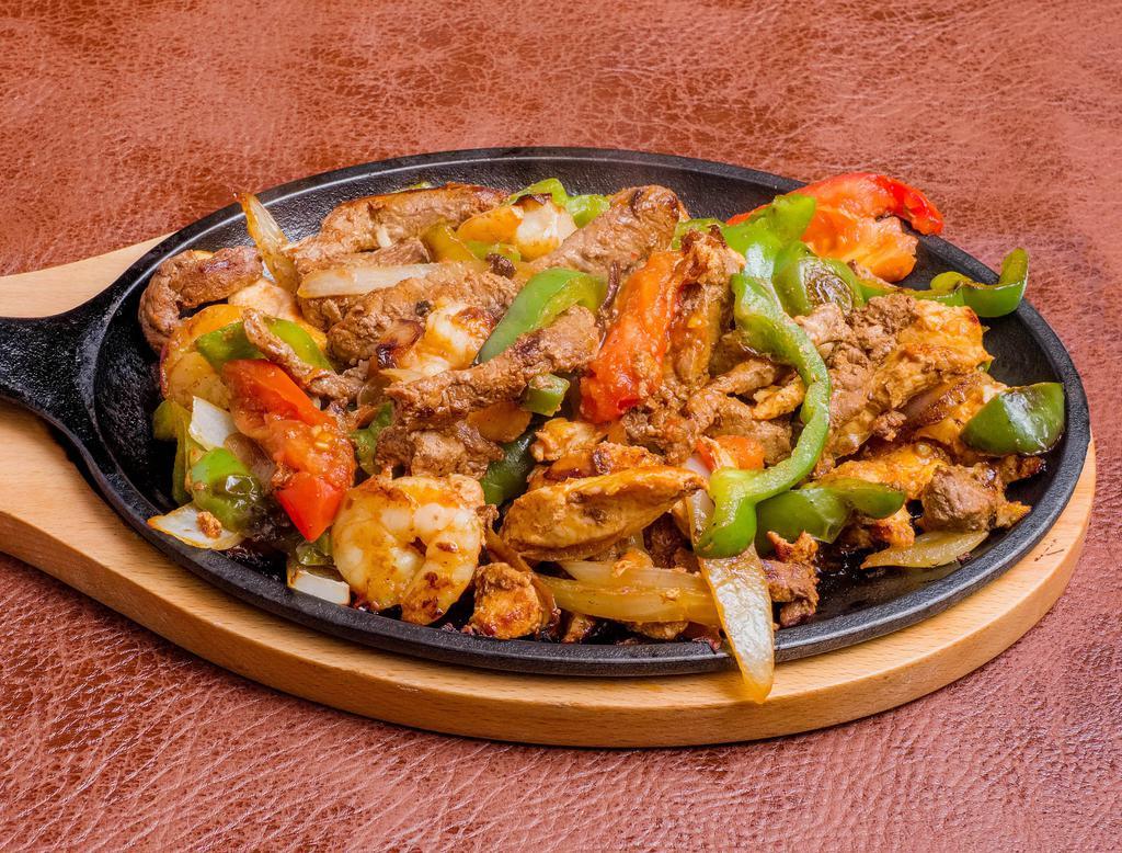 Fajita Mixtas · Mix of steak, chicken and shrimp fajita hot off the grill. Cooked with tomato wedges, peppers and sweet onions. Includes warm flour or corn tortillas, lettuce, guacamole, sour cream and pico de gallo. Served with Mexican rice and beans.