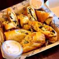 Southwestern Rolls (8 pieces) · 8 piece mini chimichangas filled with black bean corn salsa, cotija cheese, Monterey Jack ch...