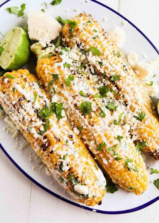 Street Corn  · Elote. Fresh grilled corn on the cob, topped with our special sauce and Cotija cheese.