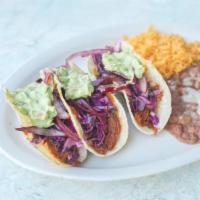 Tacos de La Casa · Soft corn California style tacos.topped with red cabbage slaw, guacamole and lime marinated ...