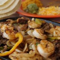 Shrimp and Steak Fajitas · Served with tortillas, rice and beans, guacamole, sour cream and cheese.