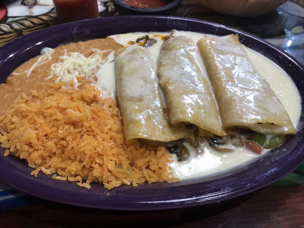 Shrimp Enchiladas · Three enchiladas filled with grilled shrimp and onion; topped with cheese sauce. Served with rice and beans.