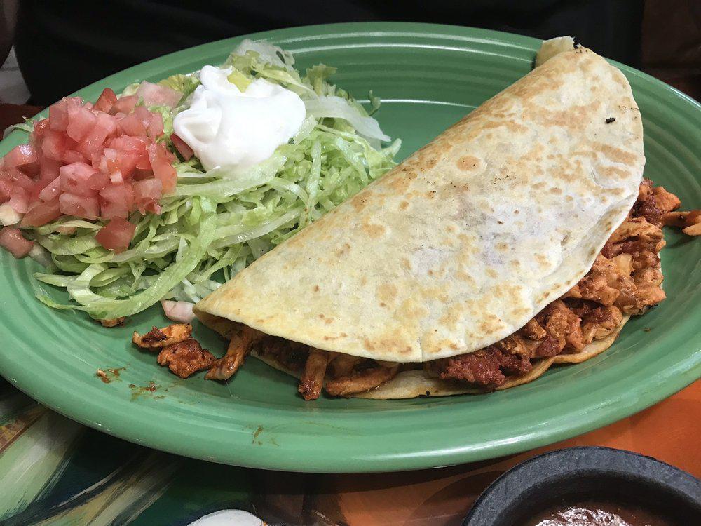 Quesadilla a la Diabla · A large quesadilla filled with grilled chicken and chorizo. Served with rice, beans, lettuce, sour cream and tomatoes.