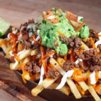 Carne Asada Fries · Seasoned fries topped with queso, meat, sour cream, sweet chipotle sauce and guacamole.