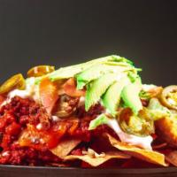Botana Nachos · Corn chips, topped with chorizo beans, chicken or ground beef melted cheese, lettuce, tomato...