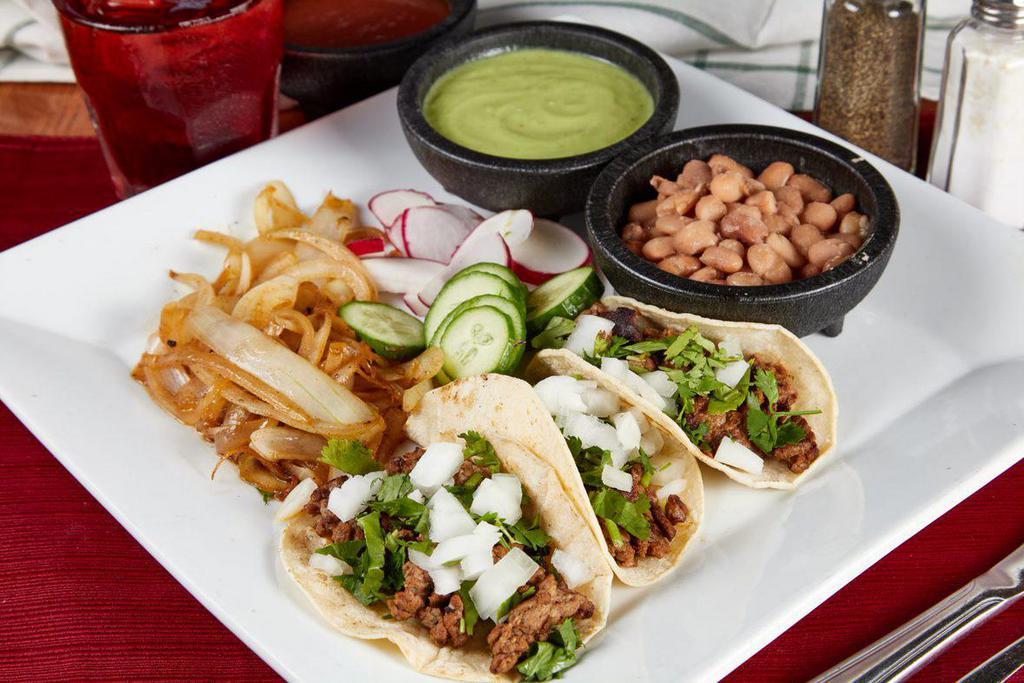 Street Tacos Meal · 3 pieces. Your choice of meat. Topped with onion & cilantro. Served with beans on the side.