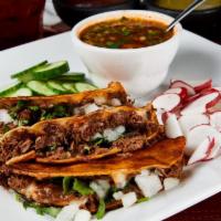 Quesa-Tacos · Cheese & birria meat atop a toasted corn tortilla. Topped with onion & cilantro. Served with...