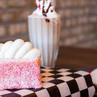 Strawberry Lamington · Yellow cake rolled in strawberry glaze and coconut.