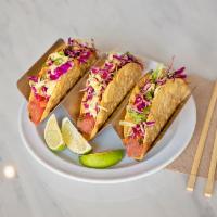 Noke Tacos · 3 pieces. Spicy sesame ahi tuna, garlic chili cabbage slaw, lime, and crispy corn tortilla.