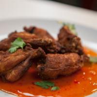 A9. Spicy Wings · Seven deep-fried chicken wings seasoned in sweet and sour sauce and Thai hot chili sauce.
