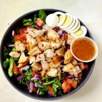 Chopped Salad · Crispy iceberg and romaine lettuce, red onion hard boiled egg, tomatoes, bacon and crumbled ...