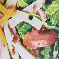 Ultimate Club Salad · Crisp lettuce blend topped with slow-cured ham, oven-roasted turkey, Swiss, smoked cheddar, ...