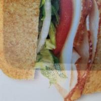 Turkey and Provolone · Oven-roasted turkey and provolone made the BLIMPIE® WAY with tomatoes, lettuce, onion, vineg...