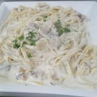 Fettuccini Alfredo with Chicken · Grilled chicken placed over fettuccini Alfredo.