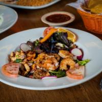 Across the Border Salad · Grilled steak, chicken and shrimp. Served on a bed of greens.