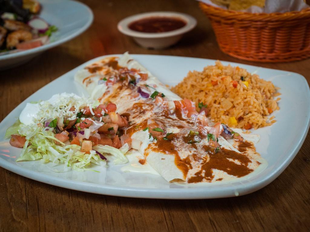 Super Burrito · Laredo's largest burrito, stuffed with grilled steak or chicken, mushrooms, onions, cheese and beans. Covered with our special salsa, pico de gallo, lettuce, guacamole and sour cream. Served with a side of rice.