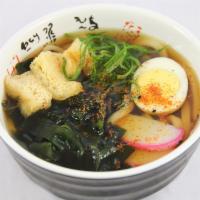Udon Soup · Thick udon noodle in hot tsuyou dashi soup topped with a half of broiled egg, fish cake (kam...