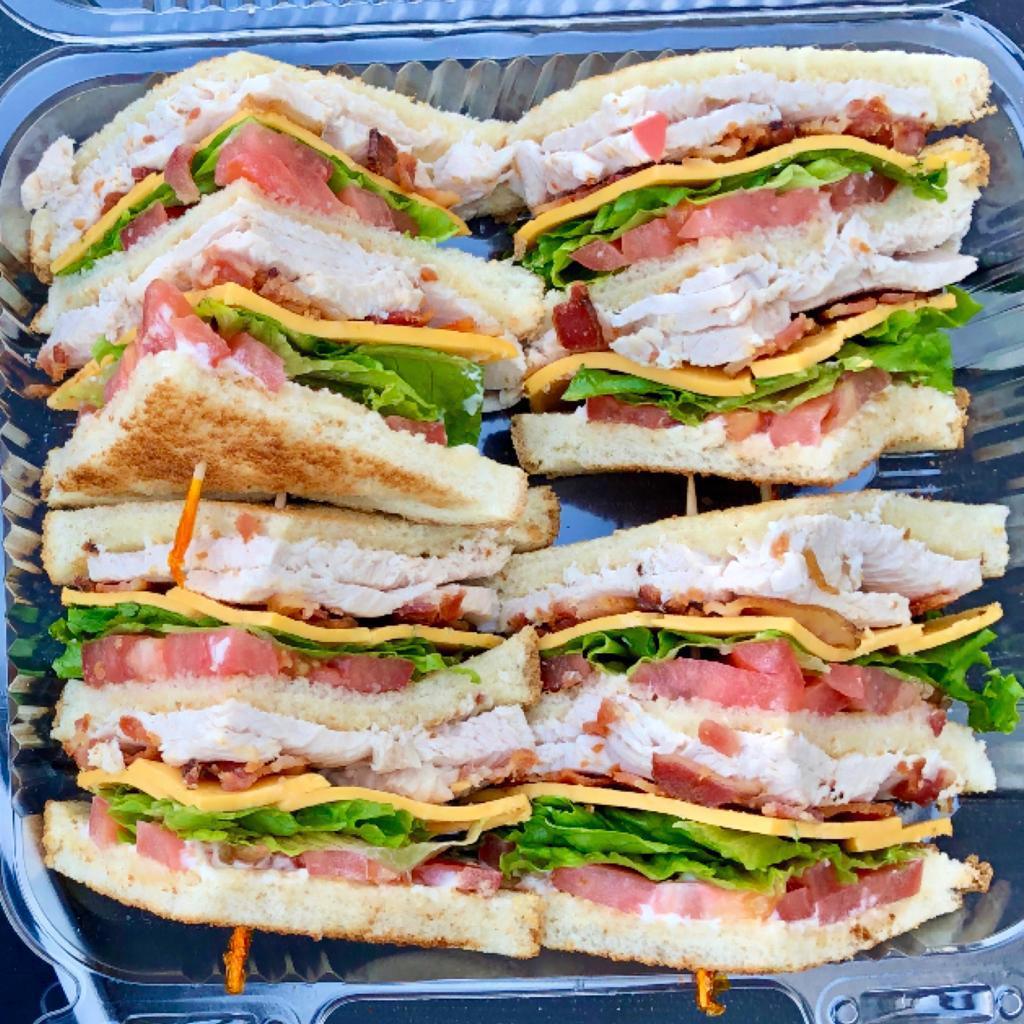 Double Decker Club Signature Sandwich · Oven-roasted turkey breast, smoked bacon, American cheese, lettuce, tomato, and mayo, on your choice of toasted white or wheat bread and served with chips