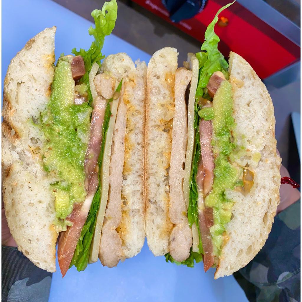 Vegan Chipotle Chickun Sandwich · chickun, pepper jack cheeze, avocado, lettuce, tomato, vegan chipotle mayo on a warm ciabatta roll and with chips