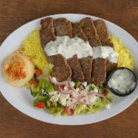 Gyro Beef Plate · Beef Gyro meat, tzatziki sauce, rice, hummus, and a side of greek salad.