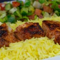Chicken Kabob · Delicious chicken kebabs hummus, salad, rice and pita bread.