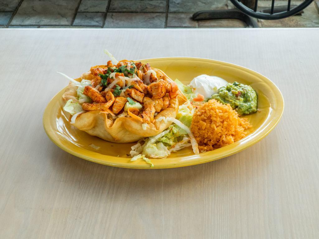 Taco Salad · Meat lettuce cheese tomatoes beans  side rice sour cream and guacamole