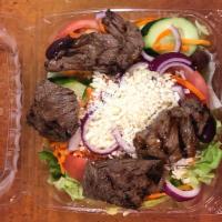 Steak tip Greek salad  · Iceberg lettuce topped with marinated steak sirloin tips ,feta cheese, Greek olives,tomatoes...