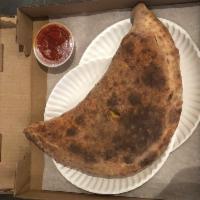 Create Your Own Calzone · Mozzarella and ricotta cheese and  topping you pick put inside with a side of marinara sauce 