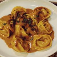 The Golden Plate- truffle tortelloni · Truffle & ricotta tortelloni, mushrooms, truffle, and creamy demi glace sauce.