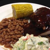 BBQ Pork Ribs · Accompanied with Cole slaw, corn on the cob and bake beans.