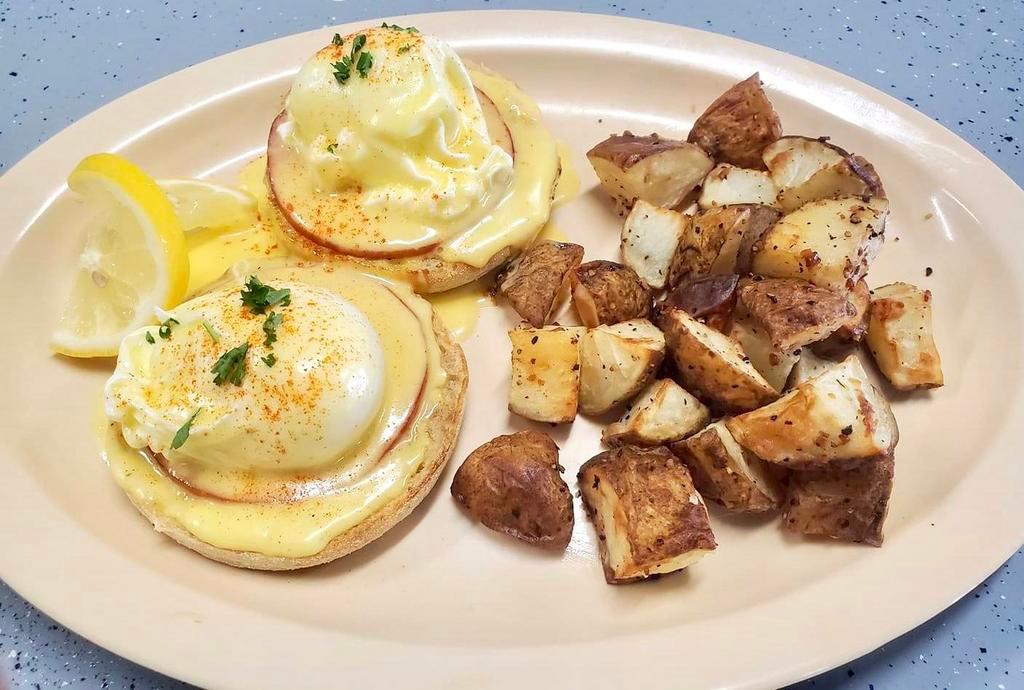 Eggs Benedict · 2 eggs poached, Hollandaise, Canadian bacon, English muffin and potatoes.