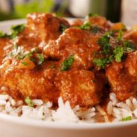 Tikka Masala Curry · Classic indian tomato based curry sauteed with your choice of protein served of a bed of bas...