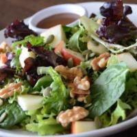 Apple Walnut Salad · Baby spinach and mixed greens with apples, walnuts, blue cheese and pumpkin seeds served wit...