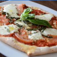 Margherita Pizza · Light tomato sauce, fresh basil, fresh mozzarella, roman cheeses, crushed tomato, garlic dri...