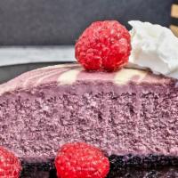 Raspberry Swirl Cheesecake · Sweet and creamy cheesecake, black raspberry puree, whipped cream, chocolate crumb crust