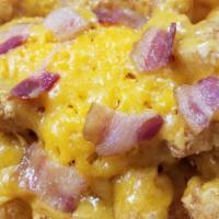 Loaded Tots · Tatar Tots, Bacon, Cheddar Cheese & Sour Cream.